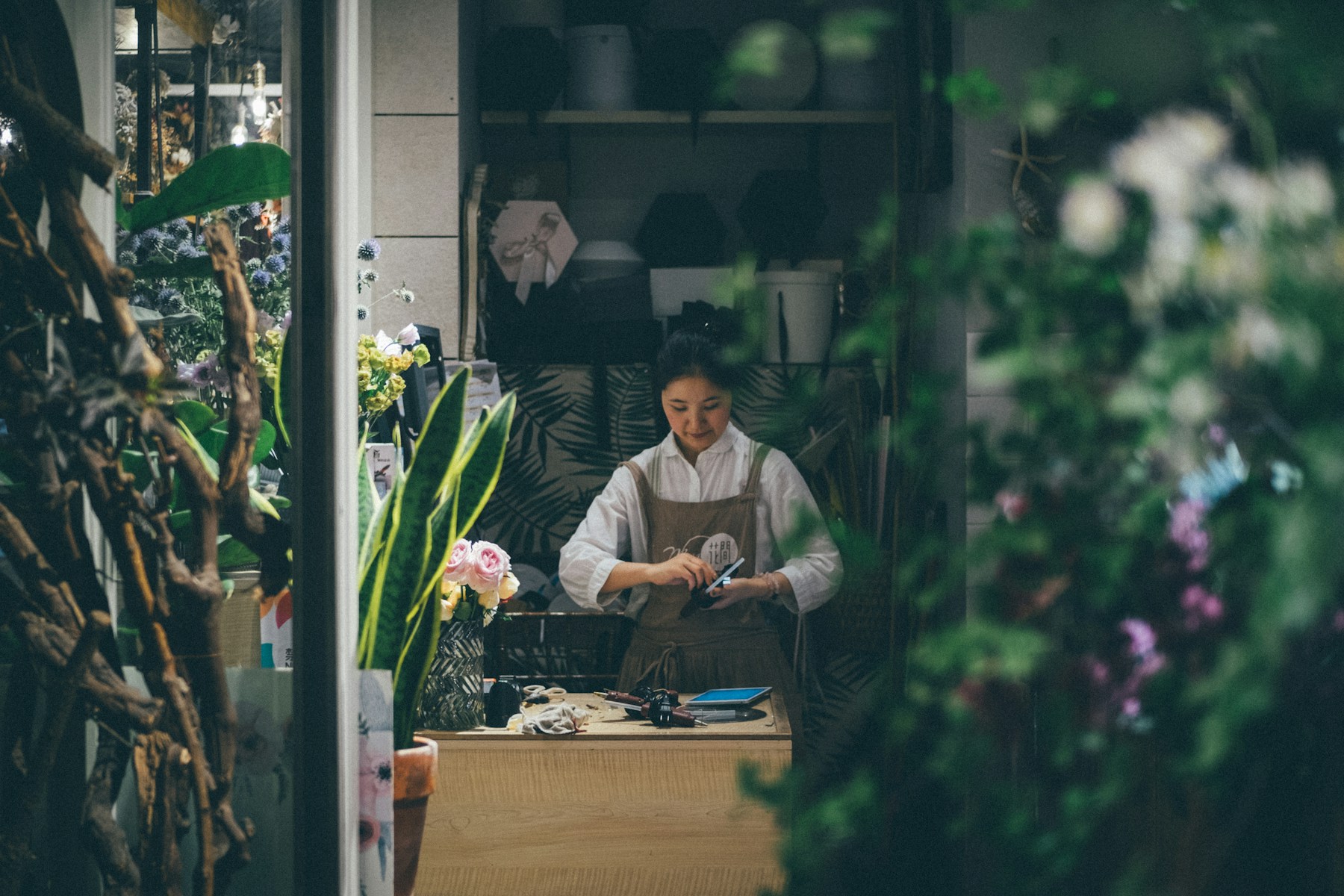 A local florist working in her neighbourhood shop